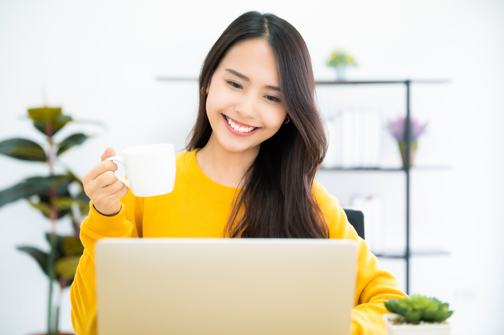 Young Woman Working From Home with Laptop